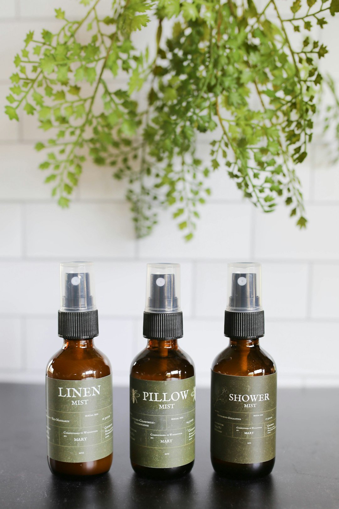 A brown glass bottle on a wooden table, like the ones in my plant-based cleaning caddy
